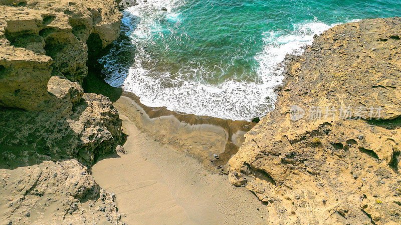 Aerial view of the hidden cove beach "La Rajita" at the natural reserve of "Monta?a Pelada" in Tenerife (Canary Islands). Drone shot